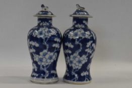 A small pair of 19th Century Chinese porcelain vases and covers, the baluster body decorated with