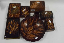 A collection of Mauchline fern ware items to include three books, three small boxes, a small vase