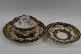 A Crown Staffordshire cup, saucer and side plate, decorated with flowers
