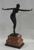 After Chiparus, a reproduction model of an Art Deco lady on stepped simulated marble base, 50cm