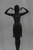 After Chiparus, a reproduction model of an Art Deco dancer on black onyx base, 77cm high