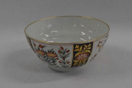 An 18th Century Worcester porcelain bowl with Kakiemon designs within blue and gilt borders, 16cm