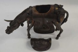 An Oriental model of a horse with saddle, 18cm high