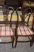 A pair of late 19th or early 20th Century mahogany framed bedroom chairs with striped upholstered