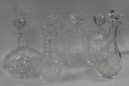 A group of leaded cut glass decanters including a pair of three ring decanters and stoppers, further
