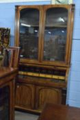A Victorian mahogany bureau bookcase cabinet with glazed top section over a base with cylinder front