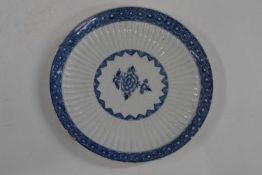 A Bow porcelain dish, the ribbed body with blue and white design (rim chips), 20cm diameter