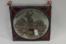 A small antique armorial lead glass panel marked Frederich Bauer over a crudely painted armorial,