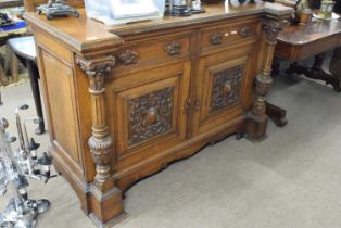 Late Victorian oak sideboard with two drawers and two panelled doors with carved decoration, 150cm