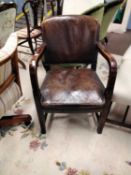 An early 20th Century brown leather upholstered open armchair or desk chair
