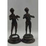 A pair of Spelter models of musicians on shaped metal bases, 26cm high