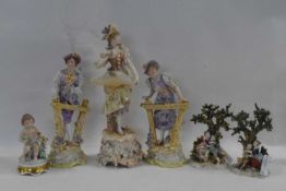 Group of late 19th Century porcelain figurines including a boy and girl standing by a gate,
