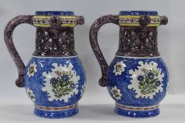 A pair of Dutch Delft puzzle jugs, probably 19th Century with polychrome design of flowers on a