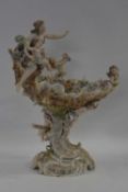 Late 19th Century continental porcelain centrepiece with the edges decorated with cherubs, raised on