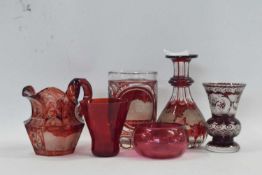 A group of bohemian glass wares including a cranberry coloured condiment bottle, lacking stopper