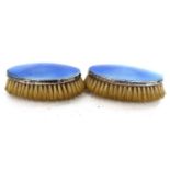 A pair of George VI silver and enamel clothes brushes of oval form having light blue guilloche