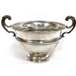 George V silver twin handled trophy cup/bowl having high scroll handles on a stepped circular