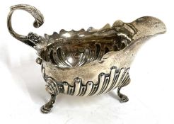 Victorian silver cream jug having a part fluted body, carved cut rim and a flying leaf capped handle