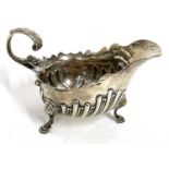 Victorian silver cream jug having a part fluted body, carved cut rim and a flying leaf capped handle