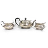 George V silver three piece tea set comprising teapot, sugar bowl and cream jug of oval form, each