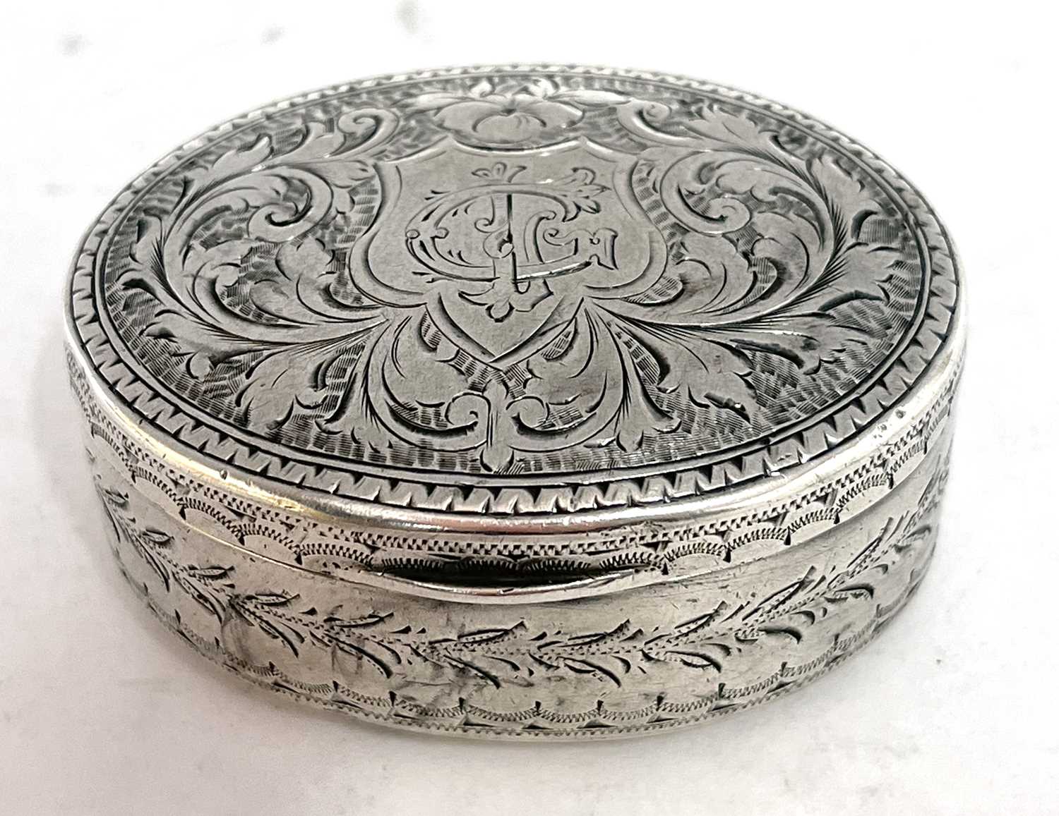 Edwardian silver snuff box of oval form, the hinged lid chased and engraved all over with scrolls - Image 3 of 7