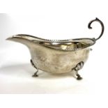 George V silver cream jug of typical form with a reeded detail border, flying cap leaf handle