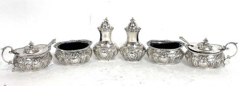 Edwardian six piece silver condiment set comprising a pair of hinge lidded mustards and liners, a