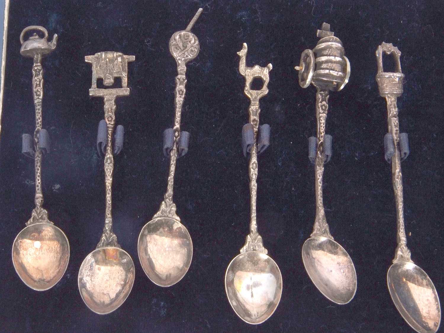 A cased set of eleven (of twelve) Spanish silver decorative coffee spoons with cast stems and - Image 3 of 5