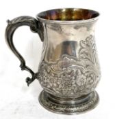 George III silver mug/tankard of baluster form to a spread circular foot with capped scroll handle