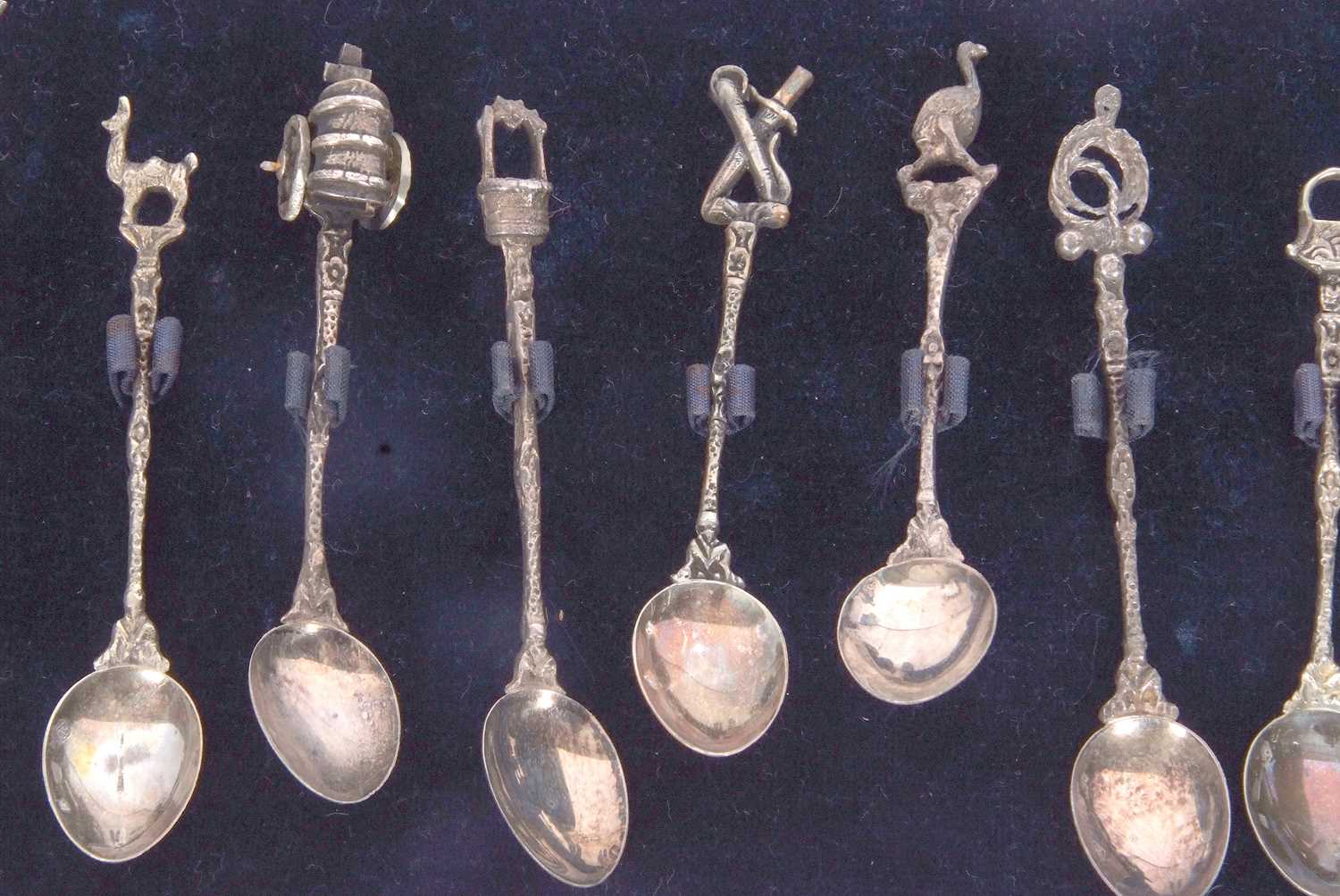 A cased set of eleven (of twelve) Spanish silver decorative coffee spoons with cast stems and - Image 4 of 5