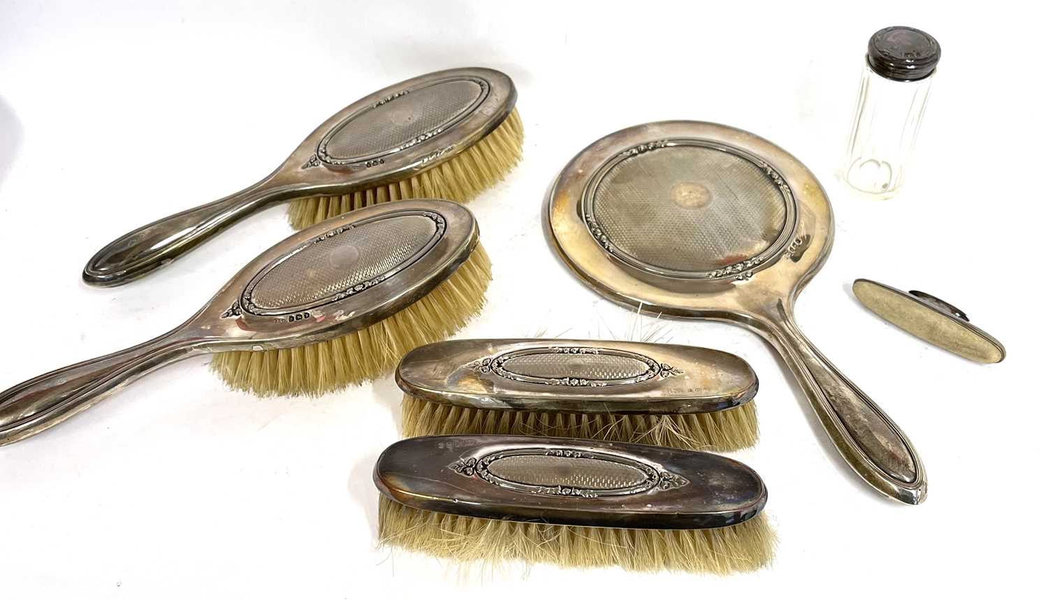 George V silver mounted cased dressing table set comprising a hand mirror, two hairbrushes and two - Image 4 of 6