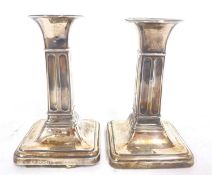 Small pair of Edwardian silver candlesticks having round capitals and square fluted colums to a