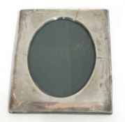 George V silver photograph frame of plain polished rectangular form having an easel back and