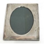 George V silver photograph frame of plain polished rectangular form having an easel back and