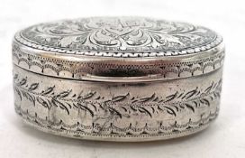 Edwardian silver snuff box of oval form, the hinged lid chased and engraved all over with scrolls