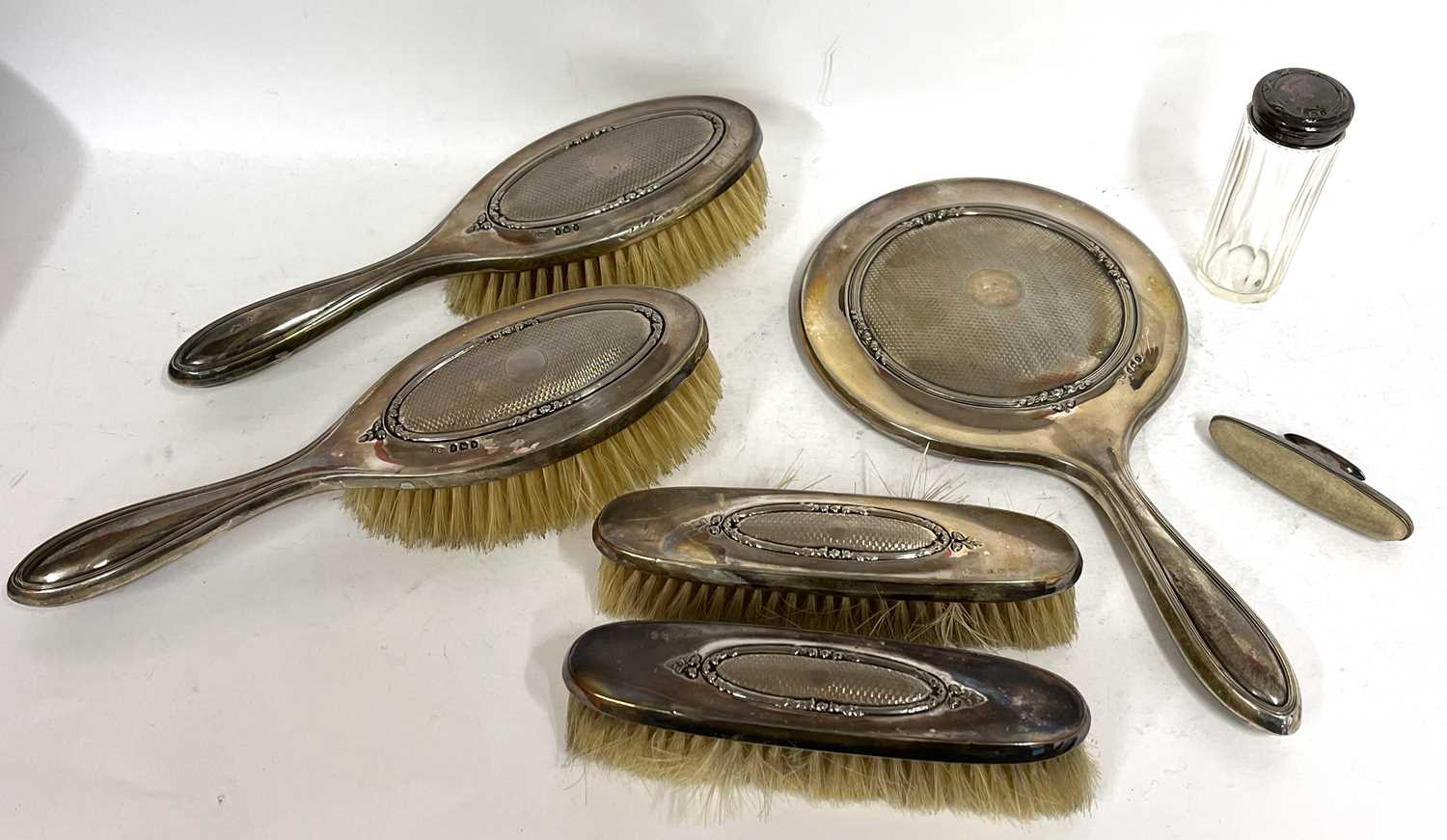 George V silver mounted cased dressing table set comprising a hand mirror, two hairbrushes and two - Image 2 of 6