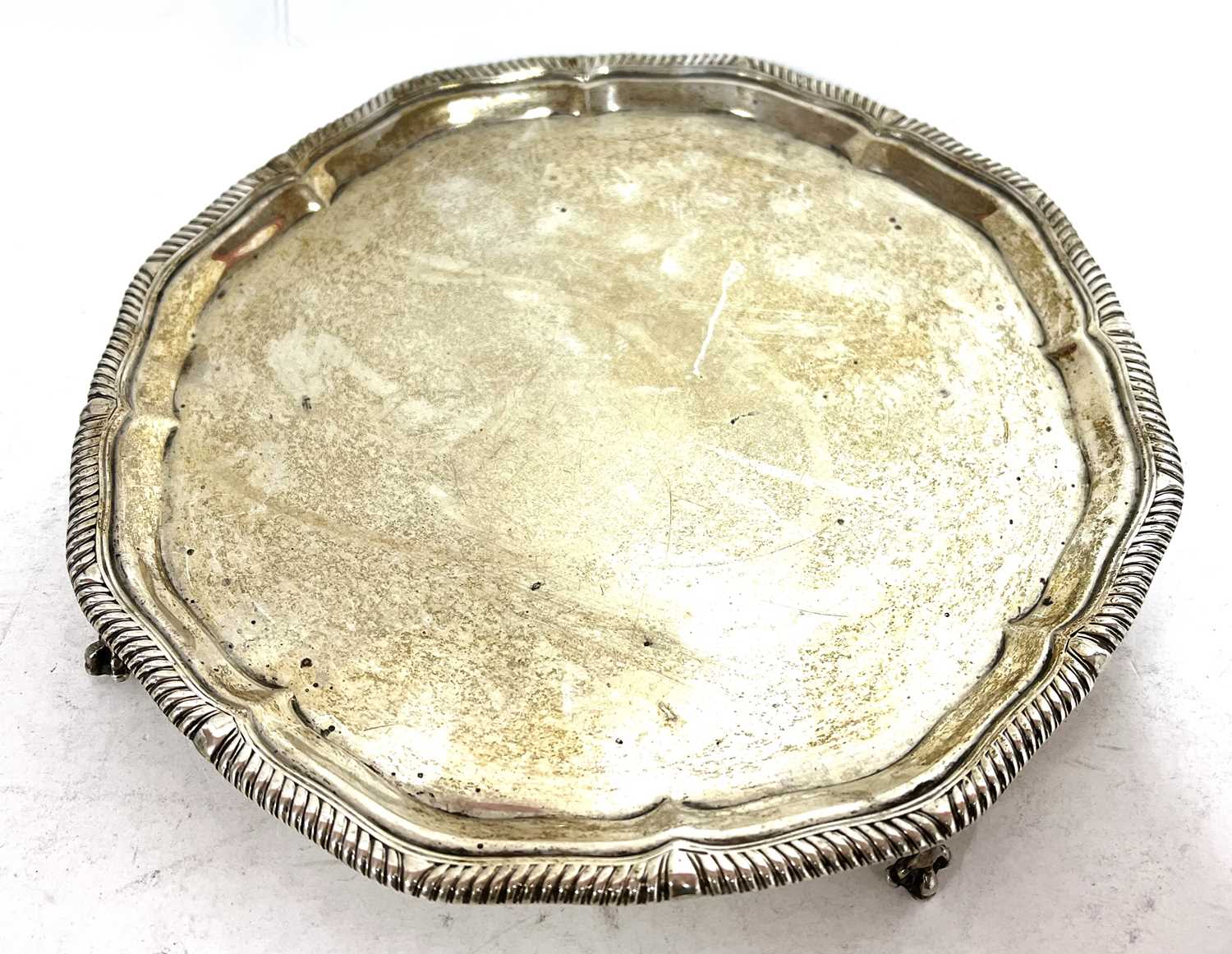 George V silver salver, the scalloped rim with gadrooned border supported on four claw and ball - Image 2 of 5