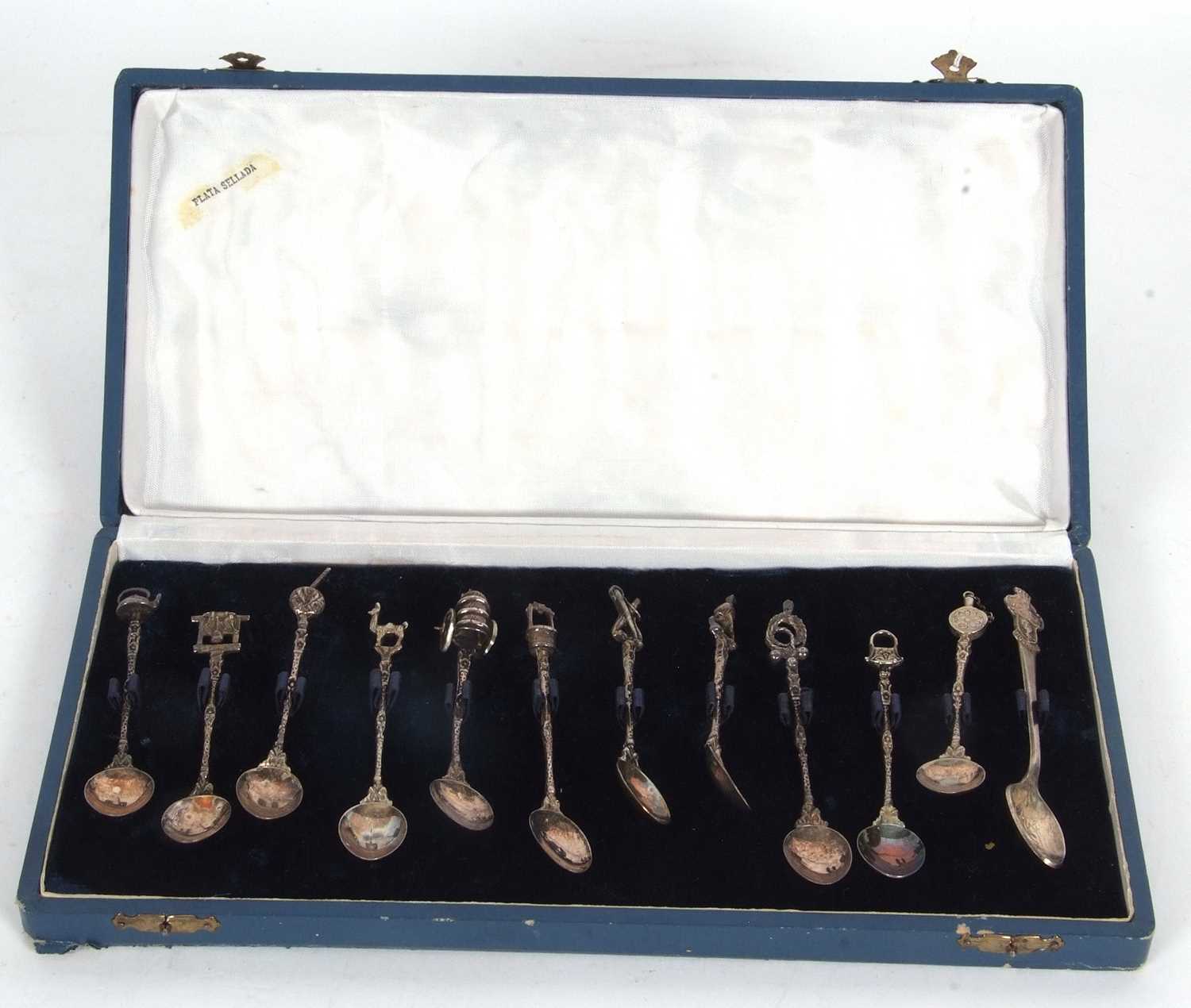 A cased set of eleven (of twelve) Spanish silver decorative coffee spoons with cast stems and