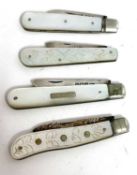 Group of four silver bladed and mother of pearl handled folding fruit knives to include two plain