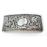 Edwardian silver card case of slight curved rectangular form, embossed with foliate and scrolls