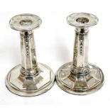 Pair of Edwardian small silver candlesticks of octagonal form, the columns decorated with ribbons to