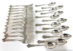 A vintage Hotchkiss & Schrevder circa 1865 matching twelve white metal spoons and twelve forks
