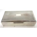 Silver cigarette box of rectangular form, the hinged lid with engine turned decoration around a