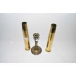 Pair of brass shell cases and a brass candlestick