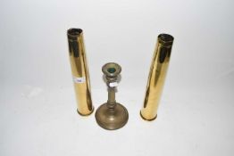 Pair of brass shell cases and a brass candlestick