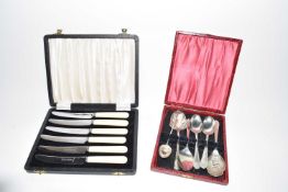 Case of butter knives and a case of various spoons
