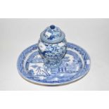 An Oriental blue and white covered jar together with a Willow pattern oval dish