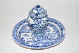 An Oriental blue and white covered jar together with a Willow pattern oval dish