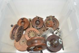Box of various vintage wooden centre pin fishing reels and associated parts