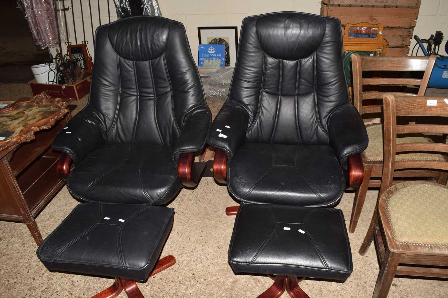 Pair of black swivel armchairs and accompanying stools